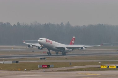 Zürih, İsviçre, 20 Ocak 2025 HB-JMB İsviçre Airbus A340-313 çok sisli bir günde 16. pistten kalkıyor.