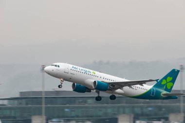 Zurich, Switzerland, January 22, 2025 EI-DEN Aer Lingus Airbus A320-214 aircraft is taking off from runway 28 on a rainy day clipart