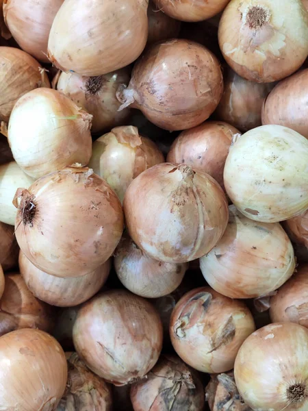 stock image top view of a layer of yellow organic unbruised onion at uptown farm in summer, advertising backgrounds