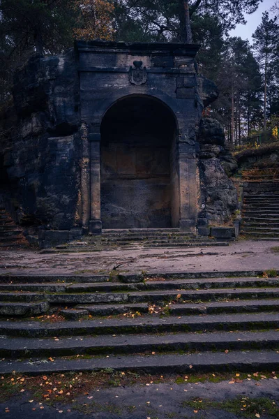 Old stone monument from old ages hidden deep in the dark woods of north Bohemia.