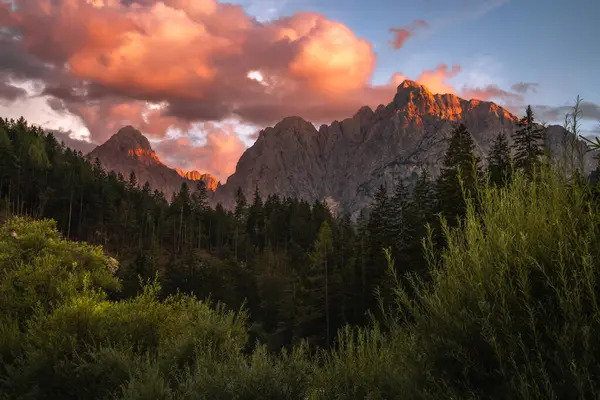 Slovenya 'nın Triglav Ulusal Parkı' ndaki Julian Alps 'in kalbindeki dağlarda romantik, renkli bir günbatımı. Güneşin tüm gökyüzünü ve bulutları renklendirdiği nefes kesici bir an..