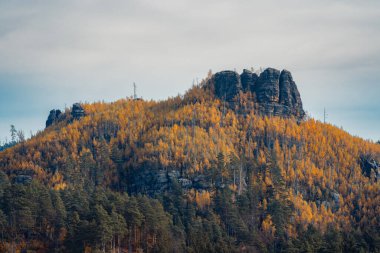 Romantic colorful sunset in the mountains of north Bohemia with the best gold colors of fall season. clipart