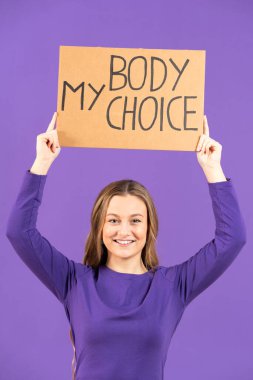 Young protestor woman raising billboard with the message 