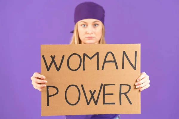Feminist activist holding billboard with woman power message isolated on purple background.