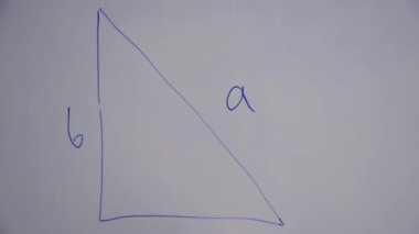 View from above of hands drawing triangle on white board to explain mathematics and trigonometry lesson