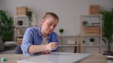 Young woman teaching math lesson online. Teacher explaining maths and trigonometry at camera