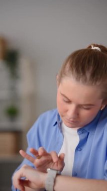 Young pretty woman talking on smart watch