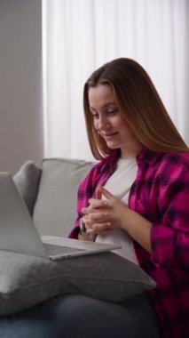 Young beautiful woman having video call on laptop. Influencer live streaming