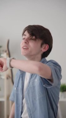 Teenager boy sending a voice message on smart watch.