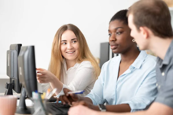 stock image Multiracial coworkers working together on computer in the office