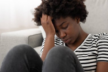 Aşırı düşünen üzgün Afrikalı Amerikalı genç bir kadının yakın çekimi. Depresyon ve yas kavramı
