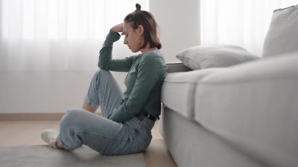 stock video Hispanic young woman suffering depression thinking while sitting on the floor at home