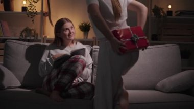 Genç bir kadın en iyi arkadaşına ya da kız kardeşine hediye veriyor. Lezbiyen çiftten hediye alan genç kız.