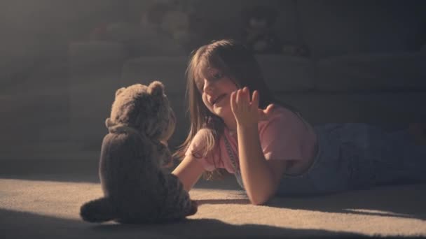 Child Playing Plush Toy Lying Floor Little Girl Talking Teddy — Stock Video