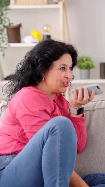 Middle Aged Woman Sending Voice Message Phone While Sitting Sofa — Stock Video