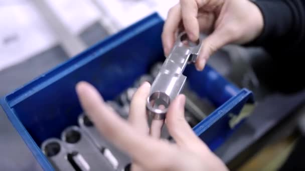 Cnc現代工場で小さな金属片の品質をチェックするエンジニアの手のクローズアップビデオ — ストック動画
