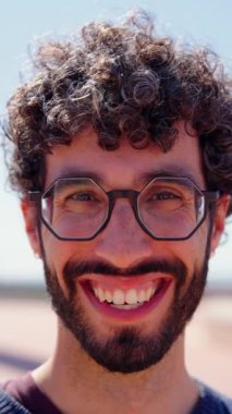 Mutlu adam gülüyor ve kameraya bakıyor. Genç hippi portresi.