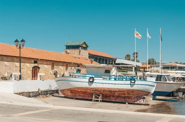 The port of Paphos in spring. Boats and ships are docked in the port.