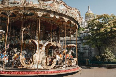 The square in front of the steps to the Basilica of Sacre Coeur in Montmartre in Paris. Carousel in summer.