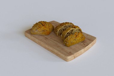 Tahta kesme tahtasındaki siyah çörekler beyaz arka planda izole edilmiş yüksek kaliteli detaylar