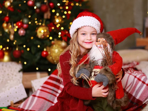 Blonde Little Girl Red Bed Holding Christmas Santa Toy — Stock Photo, Image
