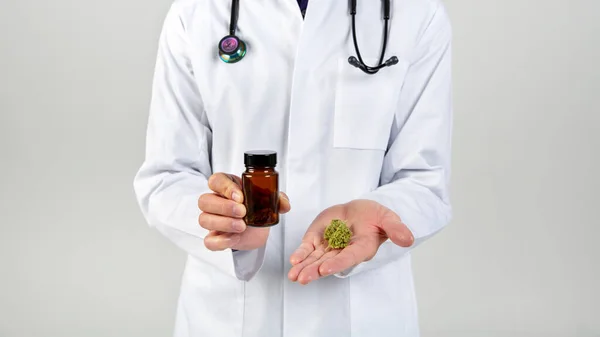 doctor wearing a gown and stethoscope showing medical cannabis-marijuana buds