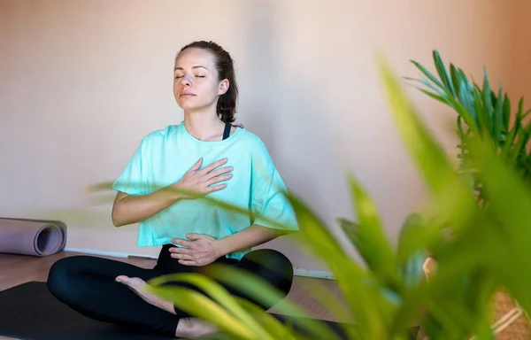Woman doing yoga breathing exercise.