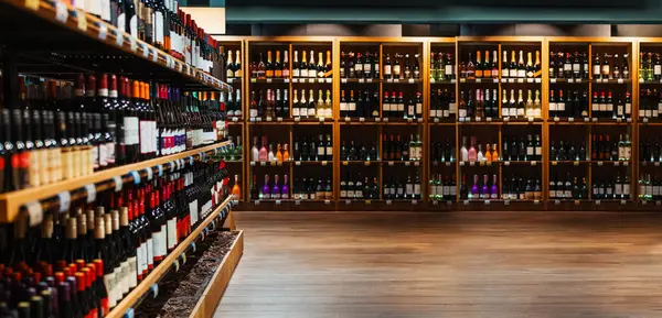 Composite image of liquor store. Wine and champaign bottles on shelves in liquor store.