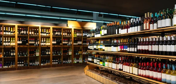 Liquor store banner. Wine bottles shelving. Alcohol business and industry.
