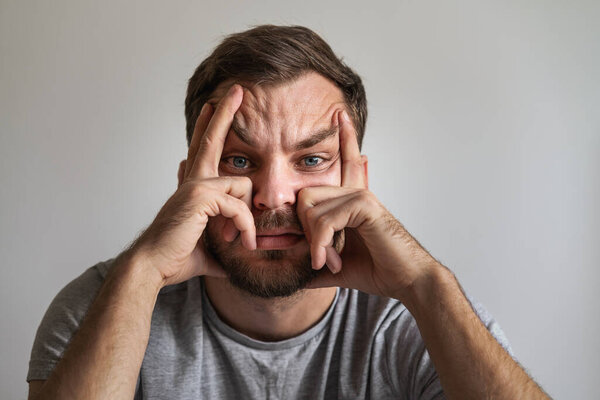 Facial expression of depressed and tired man. Face of melancholy and downcast male person.