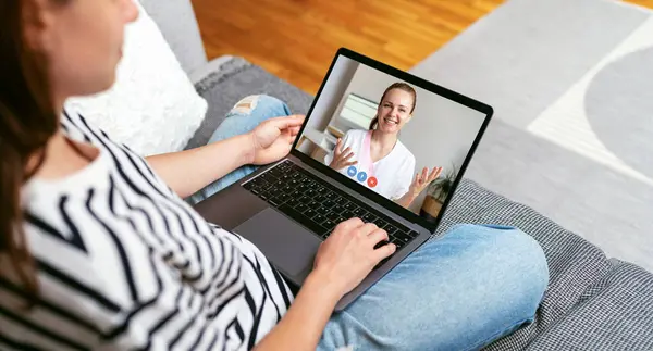 Patient video calls his doctor from home using laptop. Telemedicine, E-health. Medical consultation in the Internet.