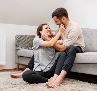 Playful loving couple has fun at home.