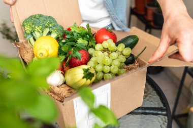 Fresh and ripe fruits in the cardboard box. Farm growing organic vegetables. Agricultural products.