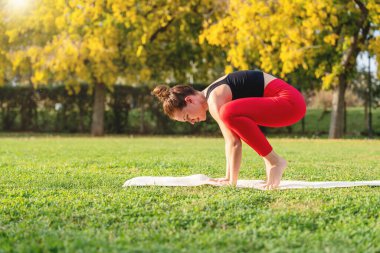 Yoga ve açık hava egzersizi. Parkta egzersiz yapan kadın..