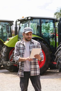 Tarımsal ekipmanlara ve dijital tablet üzerindeki kira kontratına karşı olan adam