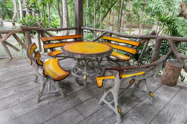 stock image Wood table and chairs in the park