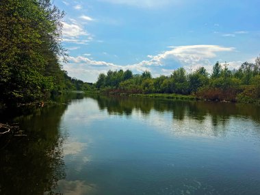 Berrak bir gökyüzü altında sakin sularla dolu bereketli bir bahar nehri manzarası sakin bir doğal ortamda Kyiv bölgesi.