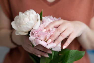 girls hands with a beautiful pink manicure design, pastel color, gently, flowers in spring. High quality photo