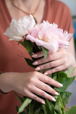 girls hands with a beautiful pink manicure design, pastel color, gently, flowers in spring. High quality photo