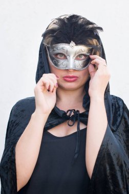 Mysterious Girl in a black cloak and a masquerade mask, mardi gras steampunk mask, a fairy tale, an enchanting story, High quality photo clipart