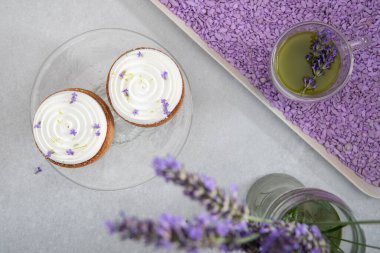 Two mousse cakes decorated with lavender flowers and matcha green tea. High quality photo