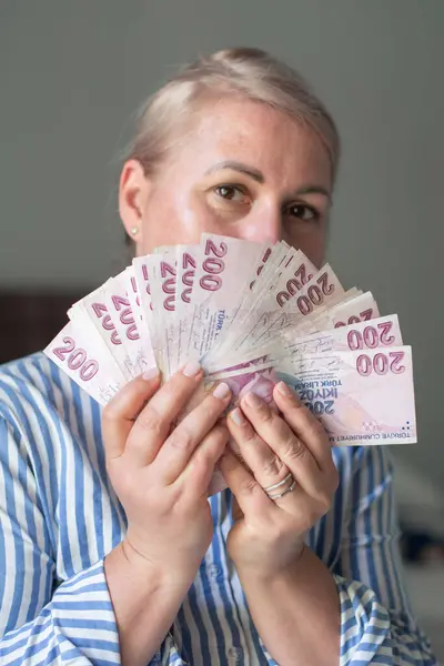 stock image a large fan of 200 Turkish lira in the hands of a tourist in Turkey, a lot of money for shopping, entertainment and travel,