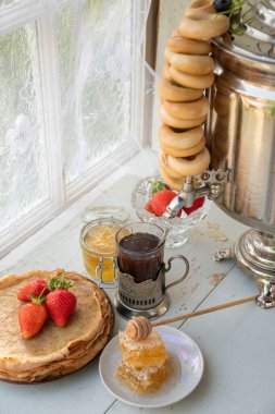 Maslenitsa için Rus geleneğinde hayat devam ediyor, ballı ve çilekli krep, simit dolu bir semaver çayı, Slav bayramı, yüksek kaliteli fotoğraf