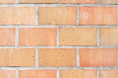 Turuncu havan bloklarının kusursuz biçimde düzenlenmiş dokusu, çeşitli mimari projelerde arka plan veya tasarım unsurları olarak kullanılan düzenli bir şablon oluşturur.,