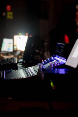 Close-up of an audio mixer in a professional studio with dramatic lighting clipart