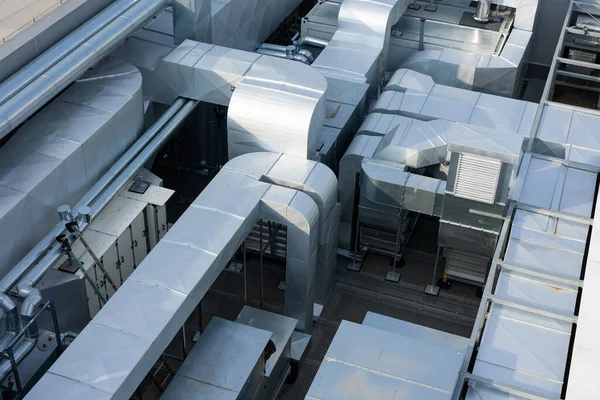 Ducts of the ventilation and air conditioning system on the roof of the building. The photo was taken in natural, soft light. View from above.