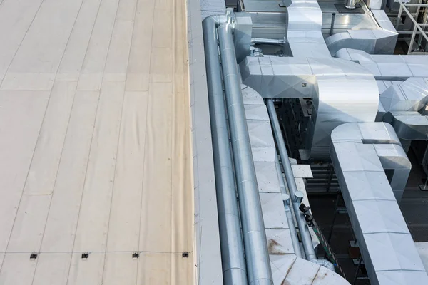 Ducts of the ventilation and air conditioning system on the roof of the building. The photo was taken in natural, soft light. View from above.