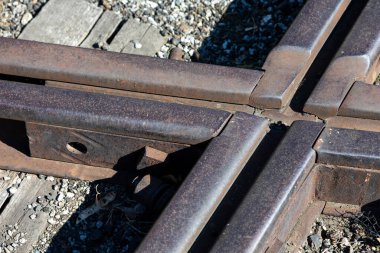 Close up for junction of railway rails on the tracks. Photo taken during the day with good lighting