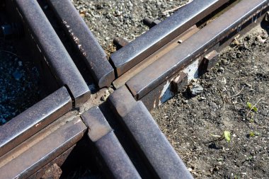 Close up for junction of railway rails on the tracks. Photo taken during the day with good lighting