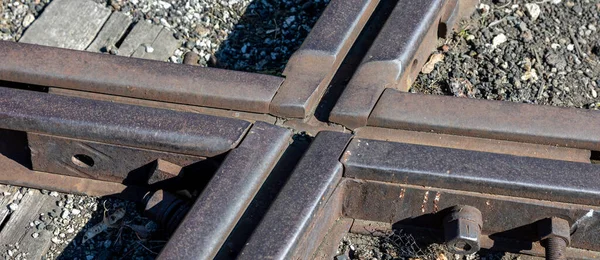 Close up for junction of railway rails on the tracks. Photo taken during the day with good lighting